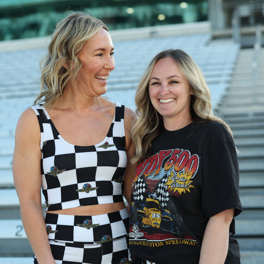 Indianapolis Motor Speedway Kiss the Bricks '47 Brand T-Shirt In Black - Front View On Model With Other Model In Checkered Tank Top & Shorts